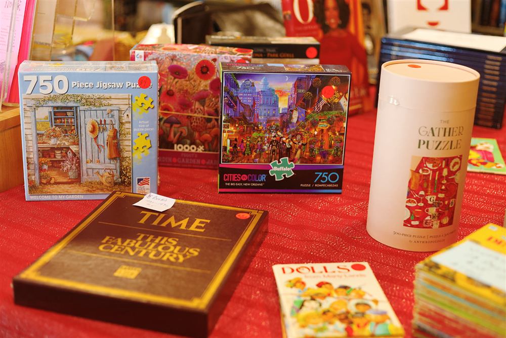 Jigsaw puzzles and books for sale on a table at the Book Nook