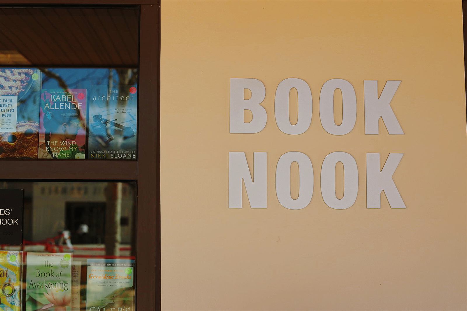 The Book Nook storefront sign beside a window display of books